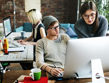 group of authors writing together on laptops