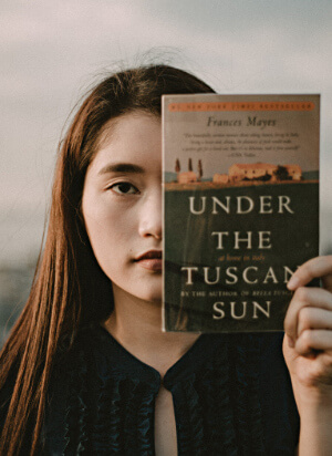 Woman holding book - Under a Tuscan Sky