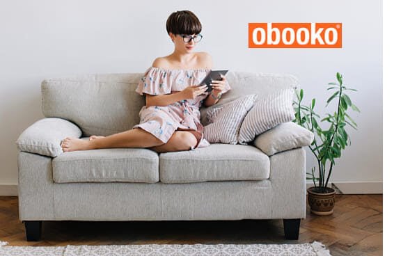 woman on sofa looking at obooko ebooks on ipad
